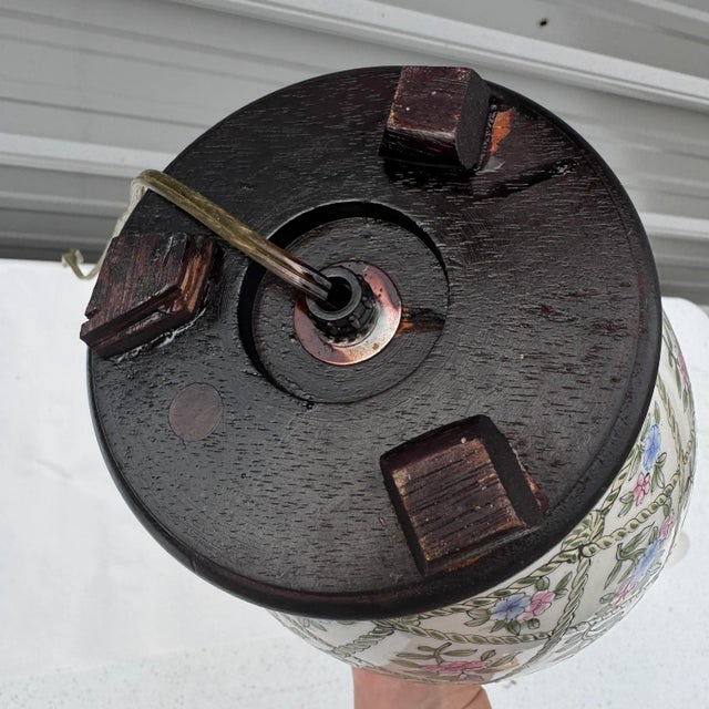 Mid 20th century chinoiserie lamp with a floral and trellis pattern. The lamp works. It does not include a harp or a...