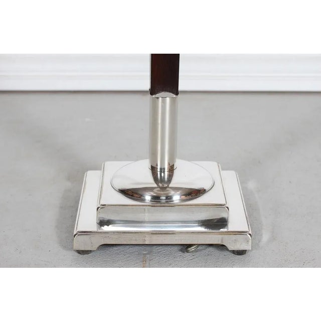 Danish Art Deco floor lamp from the 1940s made of silver-plated metal and dark mahogany. The foot and stem are of square...