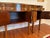Handsome figured veneers and intricate inlays enhance the sweeping serpentine lines of this majestic sideboard. The...