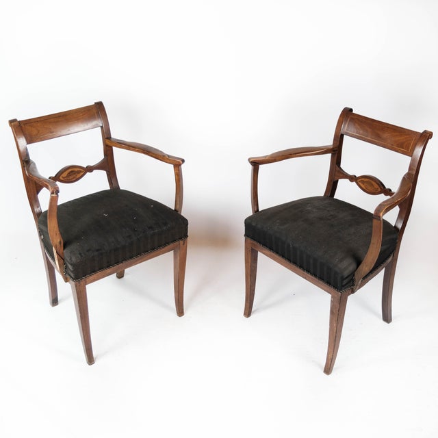 Set of two armchairs of mahogany and upholstered with black fabric, from the 1860s. The chairs are in good antique condition.