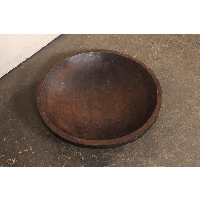 A Sumatran hand-carved wooden bowl from the early 20th century. This antique bowl from Sumatra has been masterfully hand-...