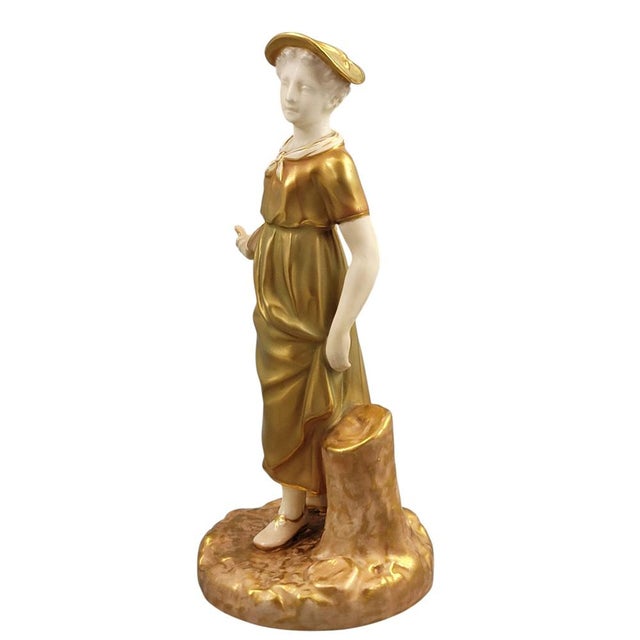 Elegant Royal Worcester bone china figure of a girl holding a bowl, model no. 1774, designed by James Hadley and issued in...