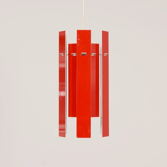 Danish hanging lamp “Cocktail” made of twelve red aluminum slats, designed by Henning Rehhof for Fog & Morup, 1972. This...