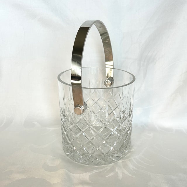 Vintage 1970s Hollywood Regency style crystal and silver-plated ice bucket. Heavy molded crystal body features a light-...
