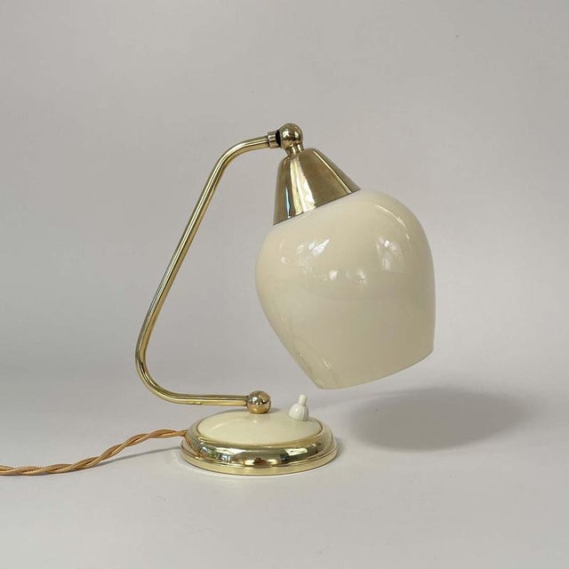 This vintage mid-century table lamp was designed and manufactured in Germany in the 1950s. The light features a sleek...