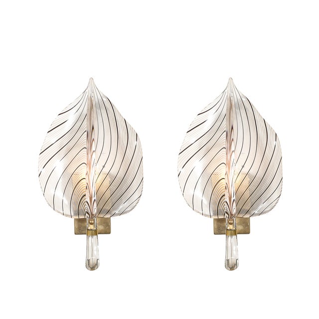 This stunning pair of Mid-Century Modernist wall sconces was designed by Franco Luce and crafted from hand-blown Murano...