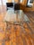 A beautifully crafted artisan coffee table and matching side table featuring hand-forged steel bases with gracefully...