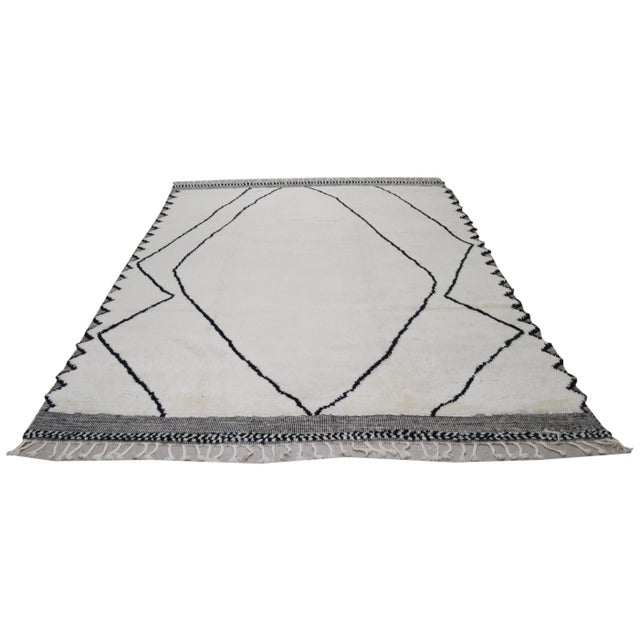Moroccan Beni Ourain hand knotted rug with geometric pattern, organic wool and soft texture.