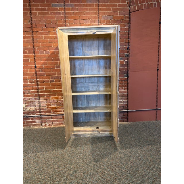 Bring soulful, global character to your space with this stunning rustic wooden armoire. Crafted with a beautiful...