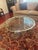 LaBarge hand-cast solid-brass oval cocktail table with a scalloped or piecrust-edge frame, inset clear glass top, curved...