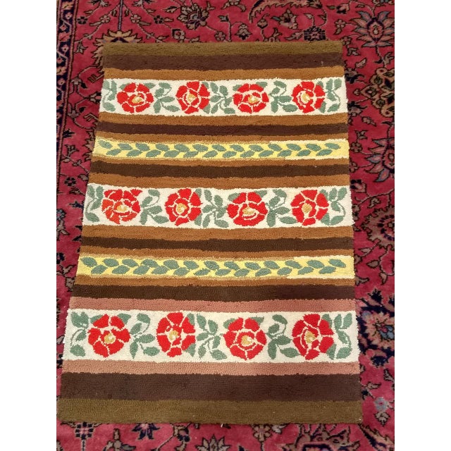 Vintage American Hand Hooked Rug from the mid 1900s in a floral pattern with bright colors including red, yellow, ivory,...