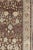 Measures: 4'5 x 8'3 This Turkish Oushak is set on a chocolate-brown background and features a light gray/taupe border. The...