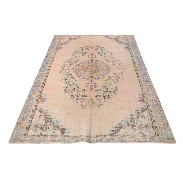 Decorative washed out handknotted vintage rug from Oushak region of Turkey. Approximately 50-60 years old. In very good...