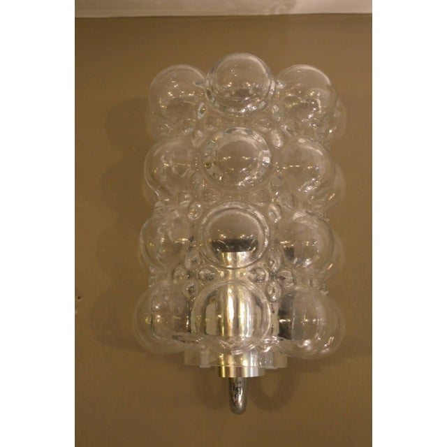 Pair of handblown glass bubble sconces, with a matching pendant chandelier. Measuring: 15" H x 10" D.