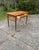 Teak and teak veneer, two drawers in the frame with pull handles in teak veneered bentwood, brass footrests, the chair in...