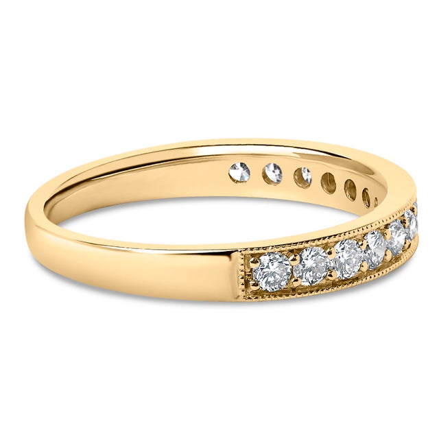 Imbued with timeless elegance, this 14k yellow gold wedding band gracefully celebrates matrimonial joy. Pave set across...