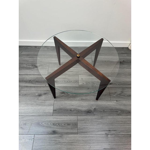 An original and iconic design circular coffee table in cherrywood by Gio Ponti, made in 1960 for the Fondazione Garzanti...