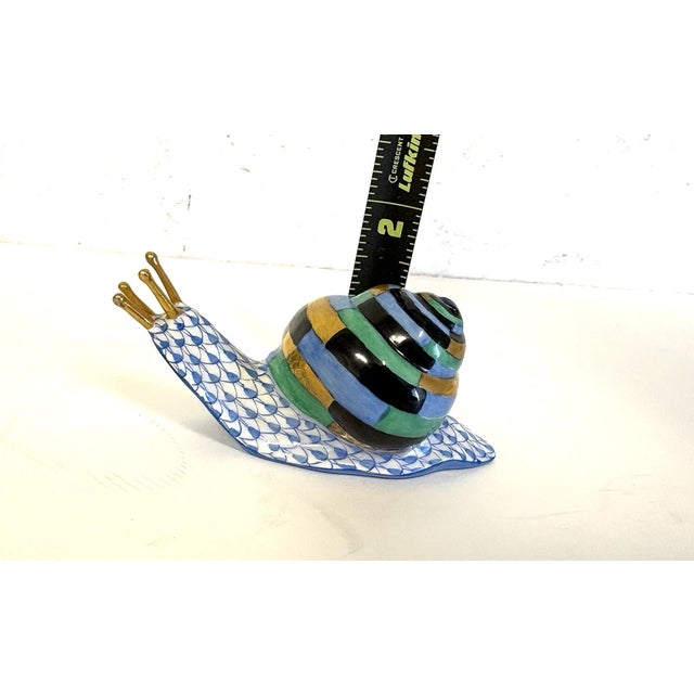 Celebrate the delicate artistry of fine Hungarian porcelain with this Herend Hand-Painted Multicolored Shell – Blue...