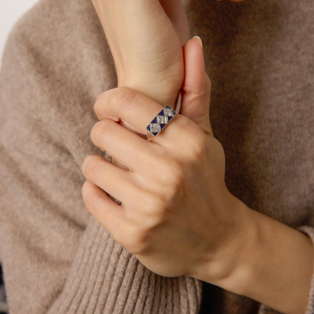 A dramatic celebration of geometric elegance, this Art Deco–inspired dinner ring showcases three luminous old European cut...