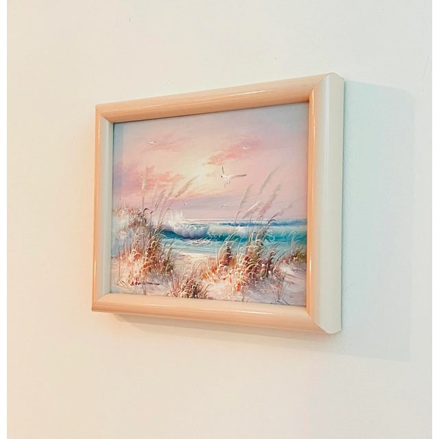 A vintage 1991 oil on canvas painting of coastal seascape with a beautiful pink sunset and breaking waves, signed by the...