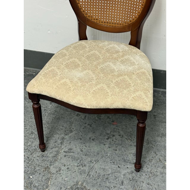 Design Plus Gallery presents a Traditional Oval Cane-Back Side Chair from The Bombay Company. The chair has a wood frame...