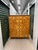 A substantial vintage craftsman chest of drawers with graphic parquetry star inlays, brass hardware, red stained sides and...