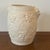 A Hartstone Pottery Bacchus white ceramic bisque wine cooler or vase featuring grape relief detailing and satyr mask...