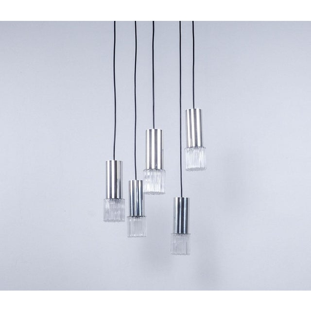 Vintage cascade pendant lamp from the 1960s, produced in Germany. The lamp consists of 5 thick glass shades with a chrome-...