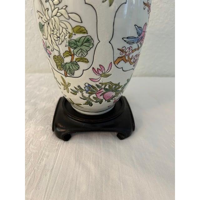 Lovely vintage Asian ceramic table lamp featuring a botanical motif around perimeter with dark brown hard molded resin...