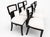 Modern set of Klismos style dining chairs. Chairs are done in a soho finish. The upholstery is white Boucle The Klismos...