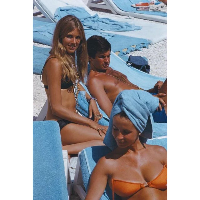 George Hamilton and Alana Collins 1968 American actor George Hamilton relaxes on a deckchair in Capri, 1968. With him...