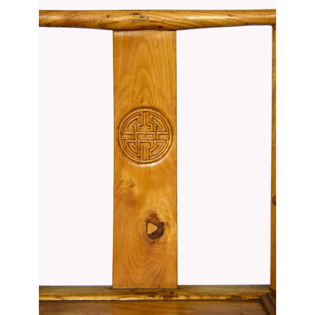 A Chinese hand-carved yumu wood accent chair with lacquered finish, carved medallion and skirt. This exquisite Chinese...