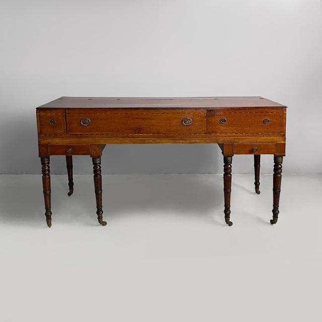 Italian desk in wood with drawers and brass handles, late 1800s Wooden desk with rectangular drop-leaf top. The front...