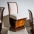 Set of four sculptural Art Deco side chairs of striking form. The curved backrest extends in a U-shape beneath the...