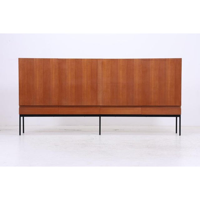 Vintage highboard B60 by Dieter Waeckerlin for Behr Möbel. The generously sized cabinet rests on a delicate black steel...