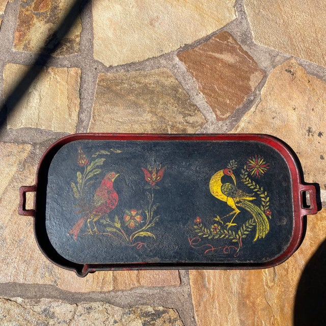 Very interesting folk art hand painted cast iron serving tray. Painted on an old cast iron skillet. Great size and colors....