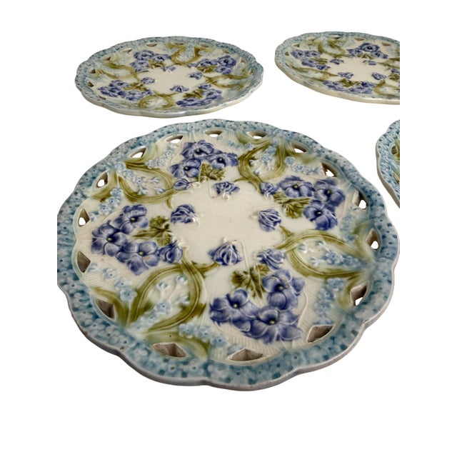 A beautiful set of six antique reticulated majolica plates by Villeroy & Boch, featuring delicate violet flowers and green...