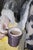Coffee for Two by Nadezda | Oil on panel Woman seated with cups, featuring portraits on her dress. For Sale - Image 4 of 5