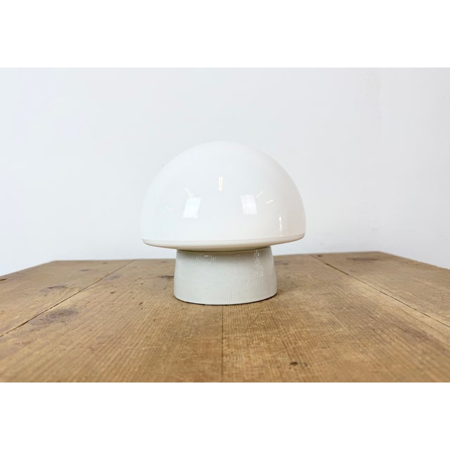Vintage industrial ceiling or wall light made in former Czechoslivakia during the 1970s. It features a white porcelain...