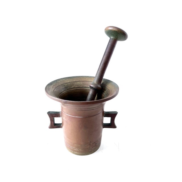 A vintage Mortar and Pestle of brass. The piece is quite patinated, but could easily be brought to a full gleaming shine....