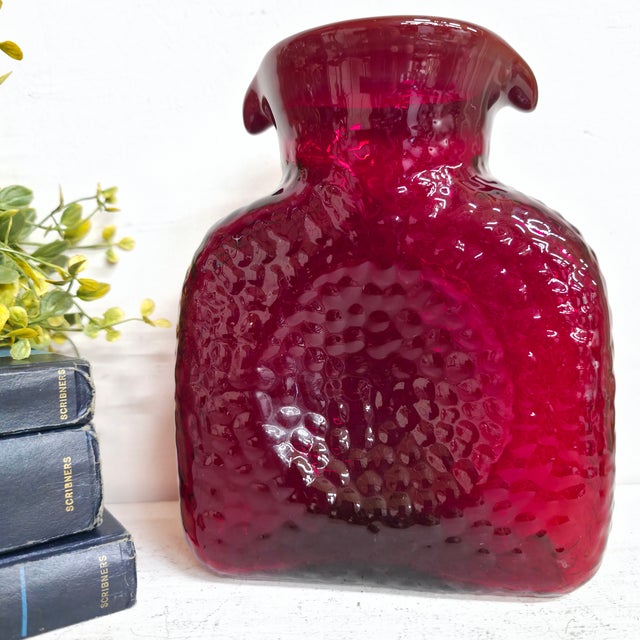 Striking vintage ruby red art glass vase with a bold, sculptural silhouette and a glossy textured / controlled-bubble...