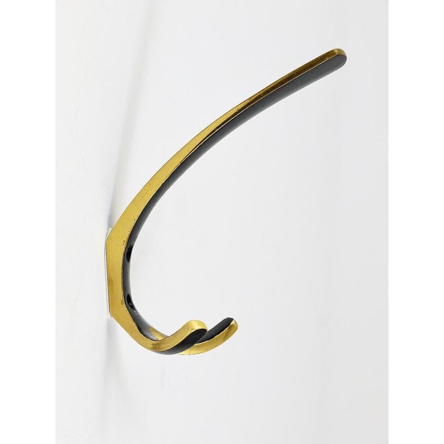 Beautiful Austrian modernist brass wall hooks, executed in the 1950s by Hertha Baller, Austria. Made of black finished and...