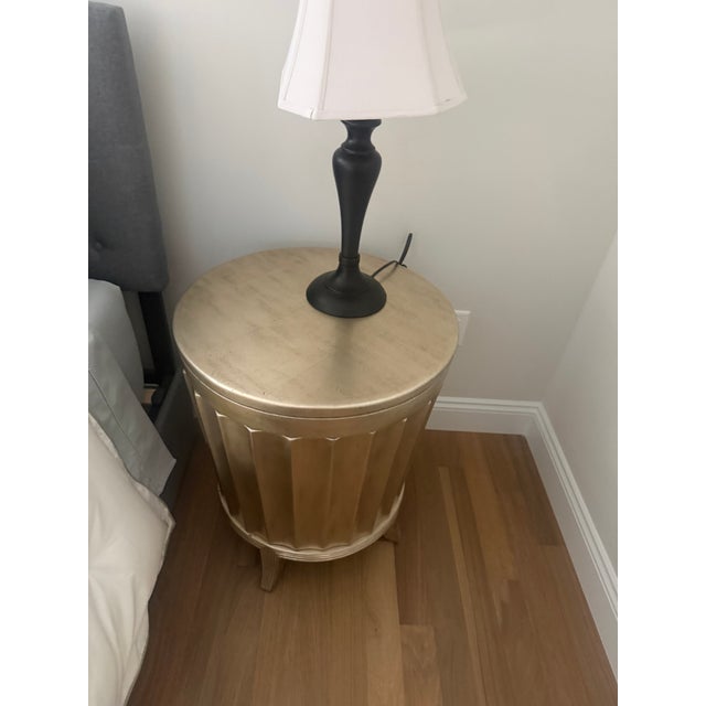 Striking pair of Neoclassical-style gold fluted drum nightstands featuring removable tops and exceptionally generous...