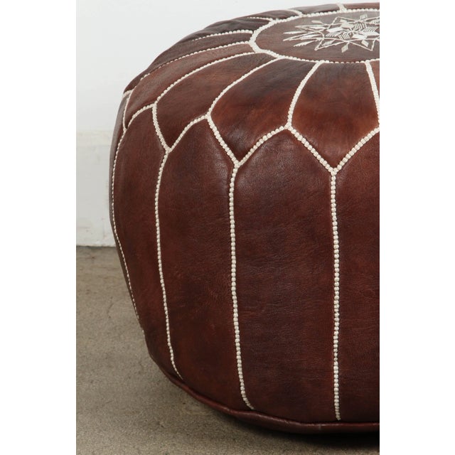Moroccan handcrafted brown leather ottoman, with embroideries. Could be used as a stool, side table or ottoman. The...