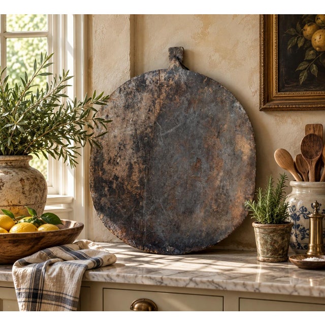 A substantial late 19th-century French bread board with the wonderfully irregular surface and mellow patina that only...