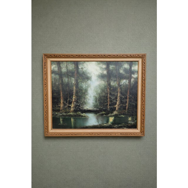 This large-scale vintage oil painting captures a serene forest scene with soft, diffused light breaking through towering...