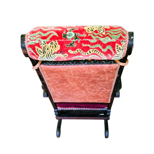 Victorian platform rocker with Navaho blanket pillow and Snow Leopard upholstery head pillow. Burgundy mohair upholstery....