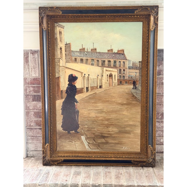 Large vintage oil on canvas depicting an elegant woman in period dress along a quiet European street. The architectural...