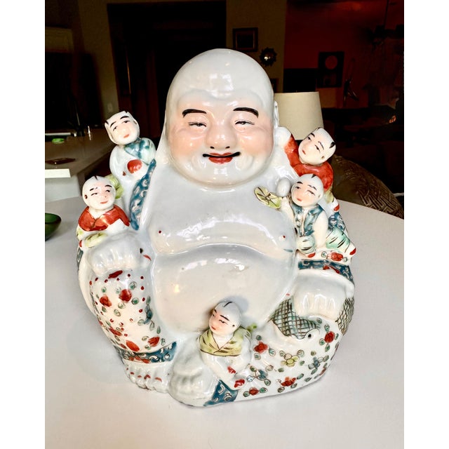 Chinese Qing Dynasty Famille Rose porcelain sculpture of the Hotei Laughing Buddha (Budai) with hand-painted multicolored...