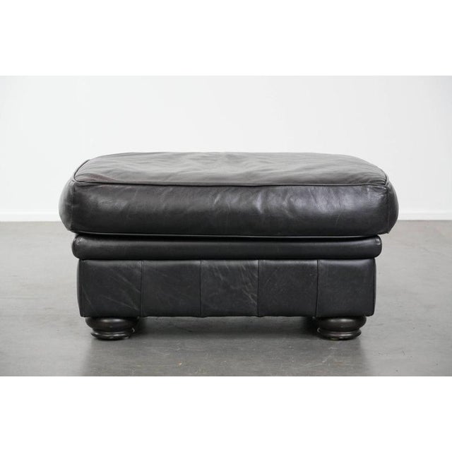 Large and timeless black ottoman made of English-style cowhide. : A cowhide footstool, also called a footstool, transforms...